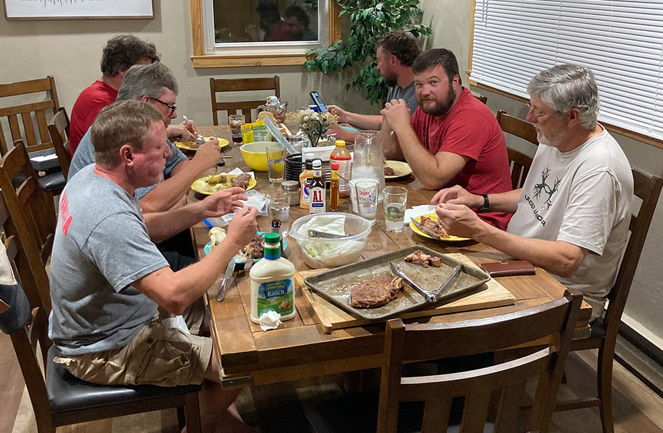 Hunters eating at the dinner table.
